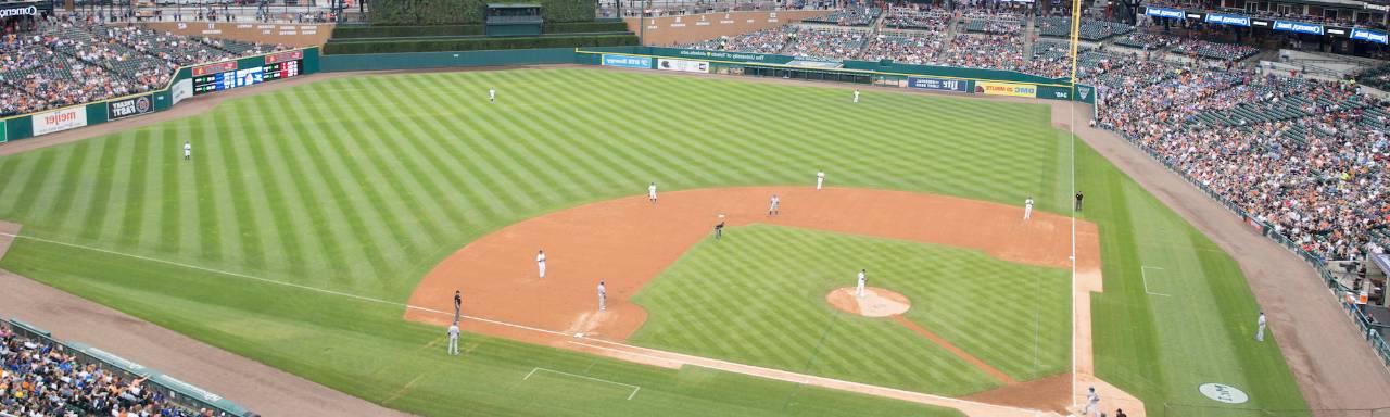 Photo of Comerica Park with players on the field and fans in the stands.